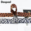 A close-up of a leopard print wide adjustable crossbody bag strap in brown and black patterns.