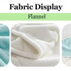 Close-up display of light blue and white flannel fabric showing various folds and textures.