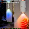 A smart night light emitting rainbow gradient and iridescent colors, mounted on a wall.