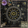 A dark fabric featuring a gold zodiac wheel and tarot cards set against a starry night background.