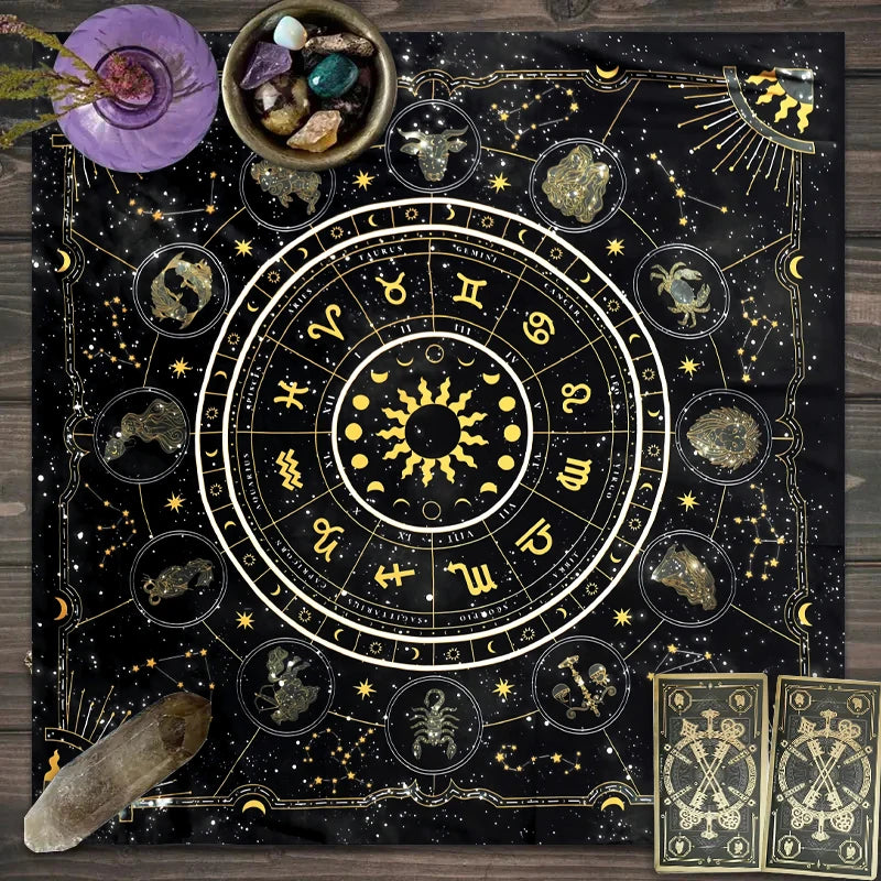A dark fabric featuring a gold zodiac wheel and tarot cards set against a starry night background.