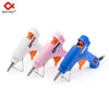 Three colored hot melt glue guns in white, pink, and blue with glue sticks