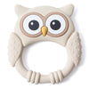 A beige silicone owl-shaped teether and rattle for babies with large eyes and textured body.