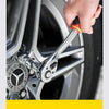 A hand is using a chrome-vanadium steel socket set and drive ratchet on a car wheel.
