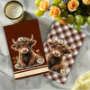 Two adorable Highland cows with floral wreaths are featured on plaid kitchen towels.