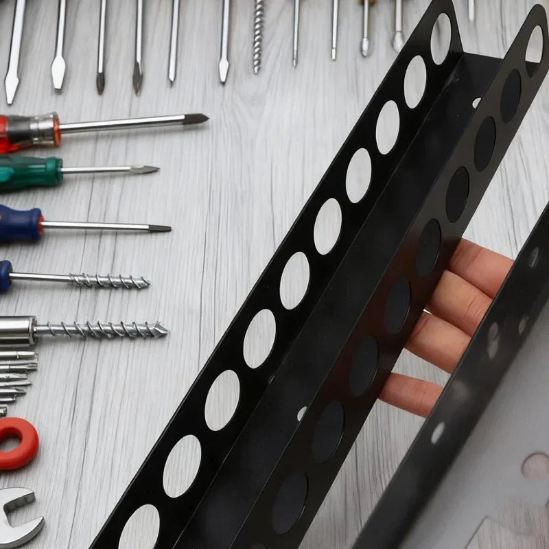A close-up view of a black wall-mounted tool organizer holding various hand tools like pliers, screwdrivers, and wrenches.