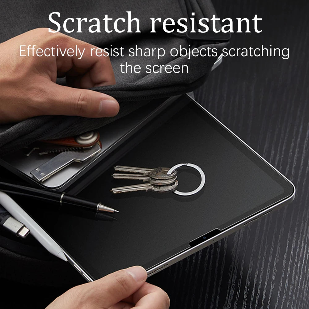 A hand is demonstrating a scratch resistant screen protector for an iPad, showing its protection against sharp objects.
