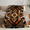 A patterned flannel throw blanket featuring geometric ethnic designs in earth tones and blues.