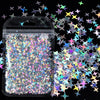 A clear plastic pouch filled with shiny holographic star sequins and glitter scattered around it.