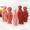 A set of five terracotta-colored 3D silicone molds depicting figures of the Virgin Mary with halos.