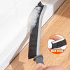 A black grout cleaning brush with hard bristles is shown against a white surface.