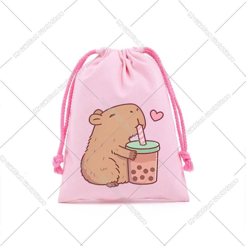 A pink drawstring storage bag featuring a cute drawing of a brown capybara holding a pink lollipop.