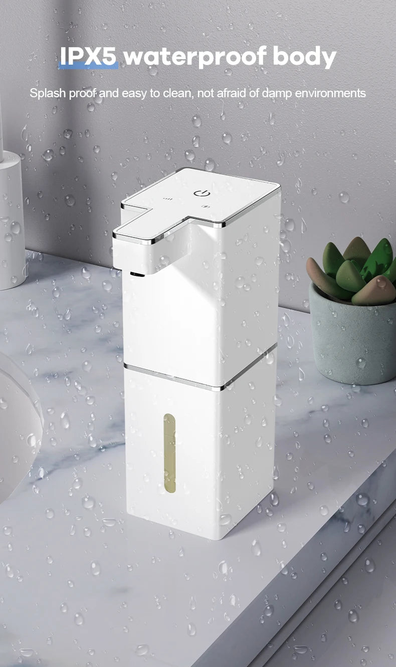 A white touchless infrared smart soap dispenser with a gold accent is shown against a background of water droplets.