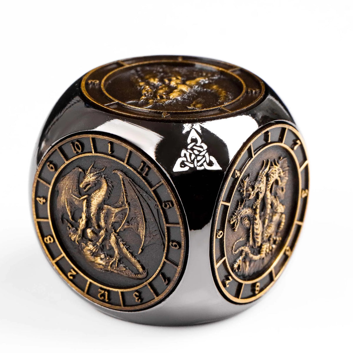 A dark metal spinner dice cube featuring intricate designs and a gold-colored top surface.
