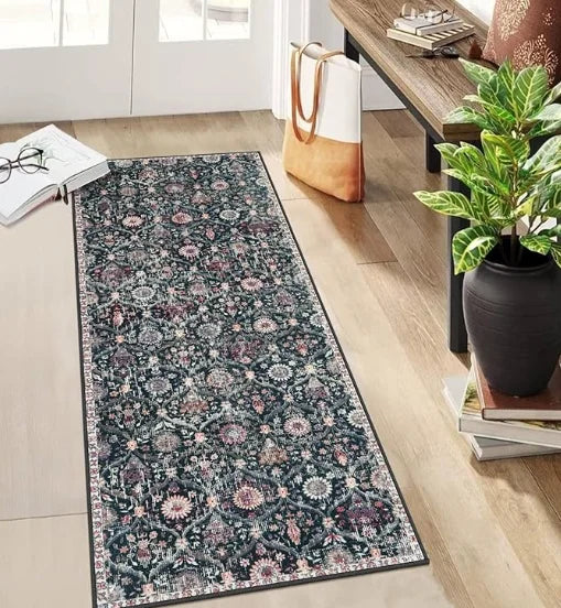 A vintage bohemian trellis runner rug with floral patterns in shades of purple and green on a light wood floor.