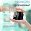 A hand holds a black portable automatic wrist blood pressure monitor displaying readings on its screen.