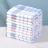 A stack of six white and blue absorbent lint-free dish cloths or kitchen towels.