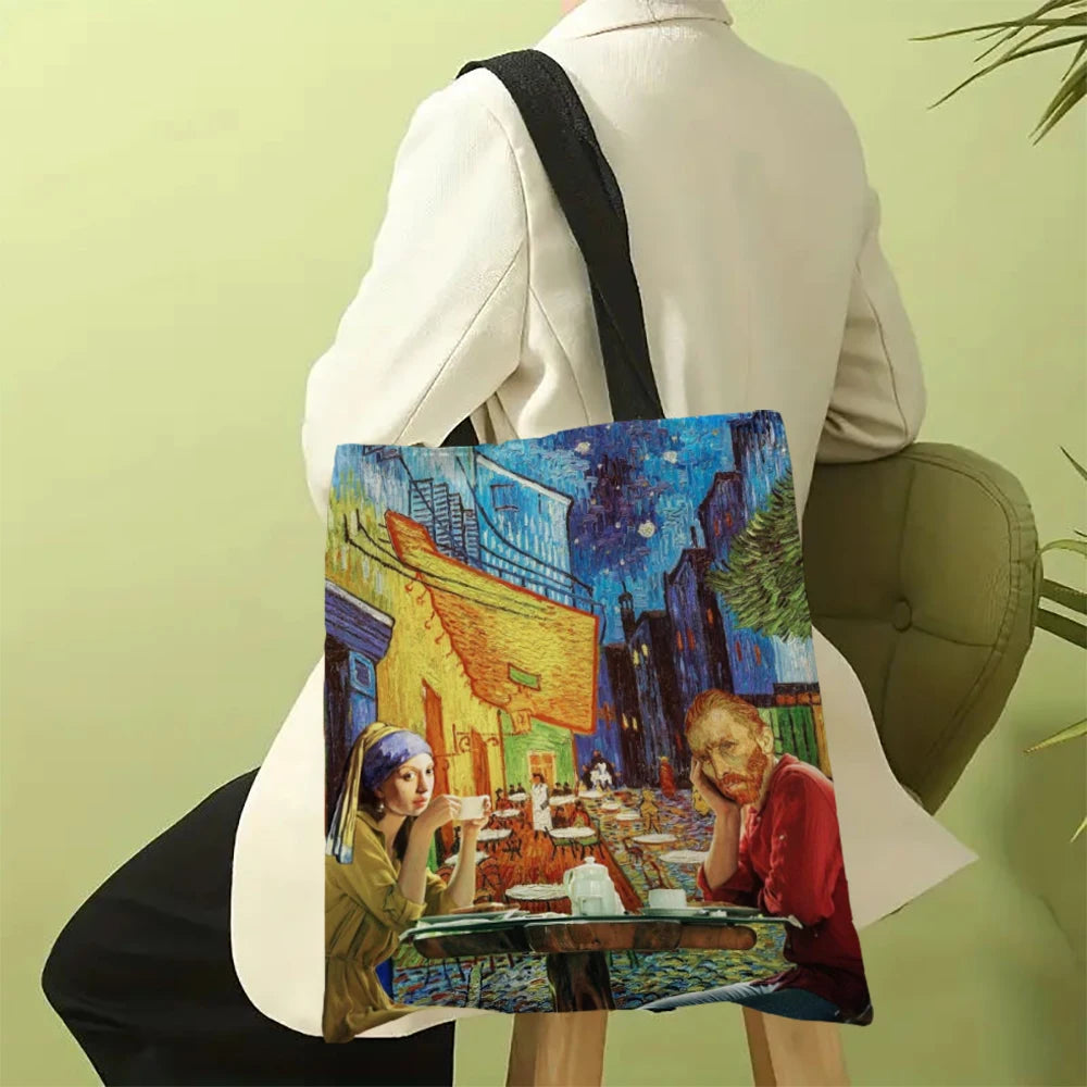 A canvas tote bag featuring a Van Gogh painting of a street scene at night, held by a person.
