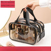 A hand is holding a clear transparent PVC travel toiletry bag with black straps and medium double pockets.