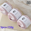 Three balls of pink glitter yarn labeled MuYuan Frost Words are displayed on a light surface.