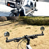 A close-up view of a bicycle with a mounted rearview mirror and a basket, showing the adjustable mirror setup.