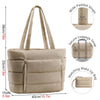 Beige quilted puffy tote bag with wide straps and a secure luggage strap