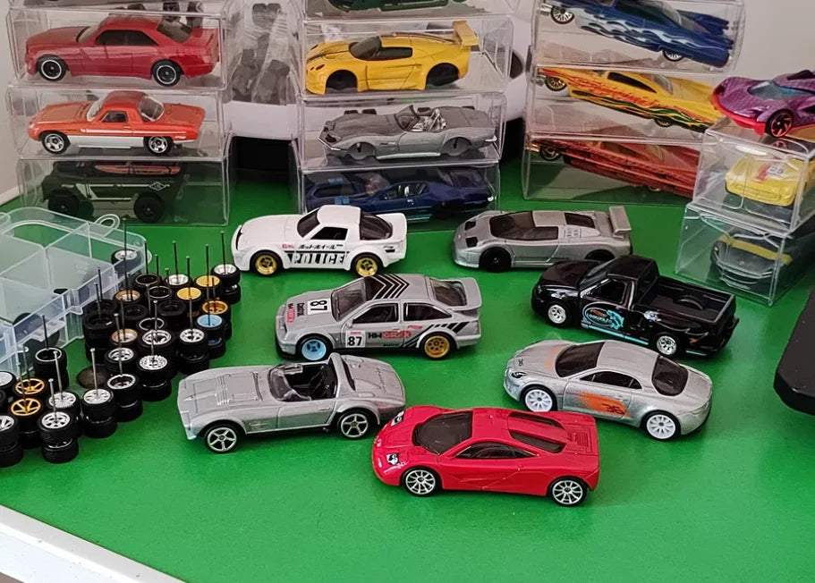 A collection of 10 pairs of 1:64 scale alloy car wheels and tires, including various colored cars and vehicles.
