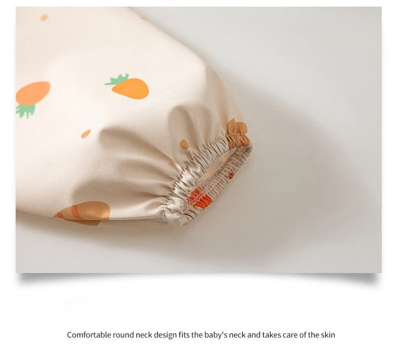 A round neck feeding bib in beige fabric with orange accents, shown lying flat.