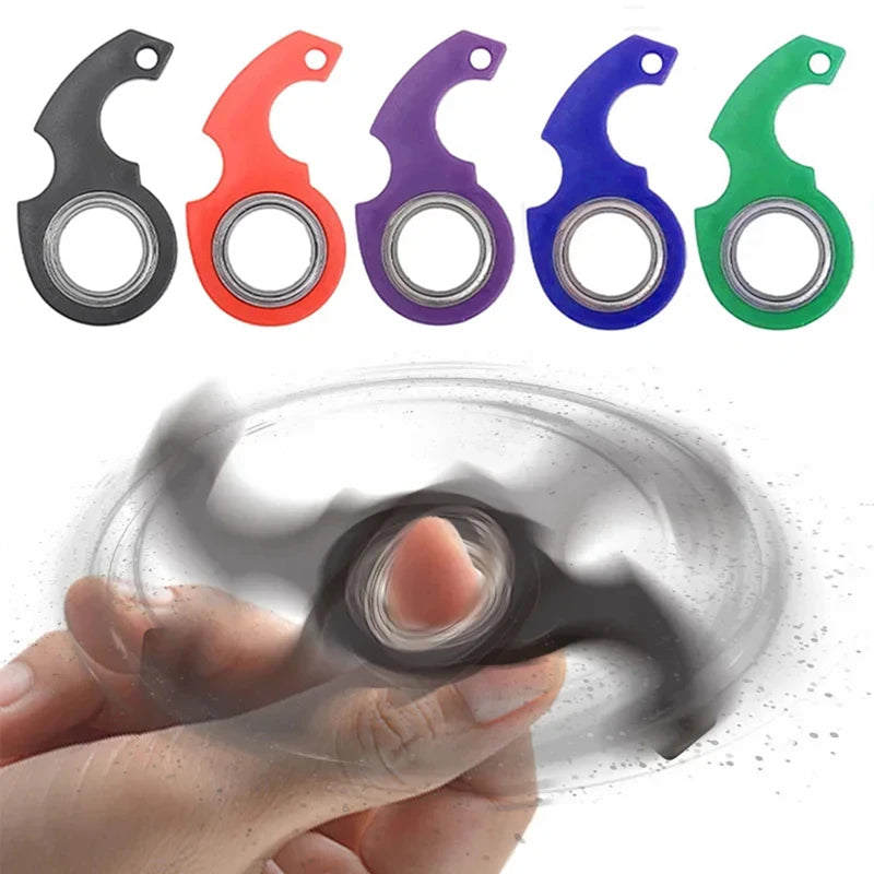 A set of six metal fidget spinner keychains in various colors, including black, red, purple, blue, and green, being held by a