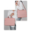 A woman is shown carrying a pink waterproof nylon laptop sleeve bag over her shoulder.