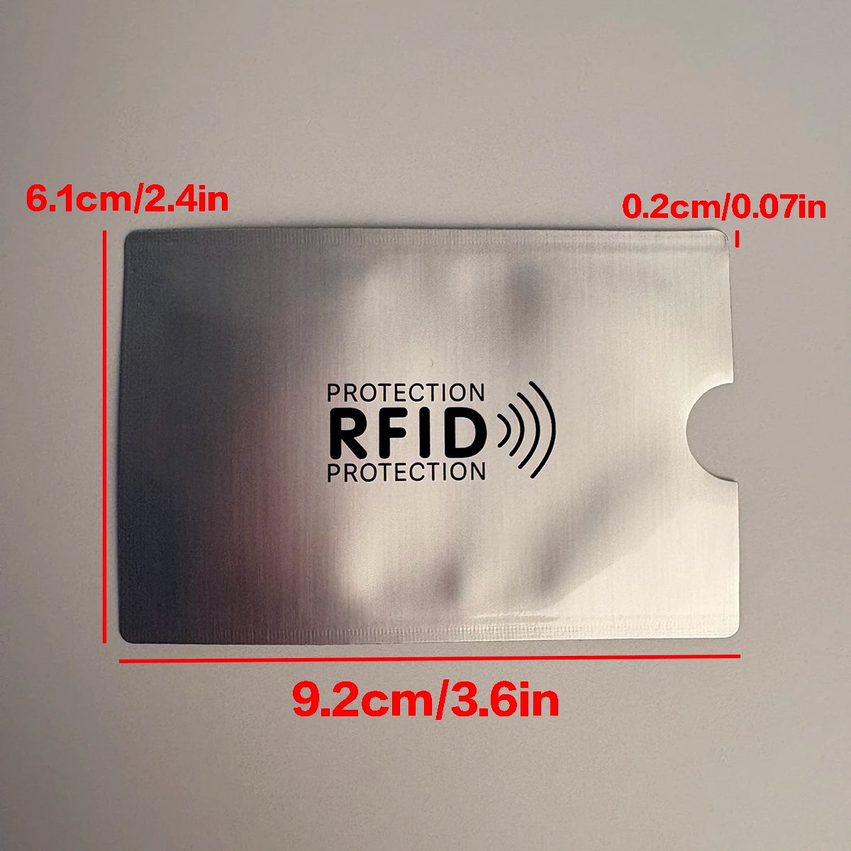 A silver RFID protection card sleeve measuring 9.2cm by 6.1cm with a protective layer.