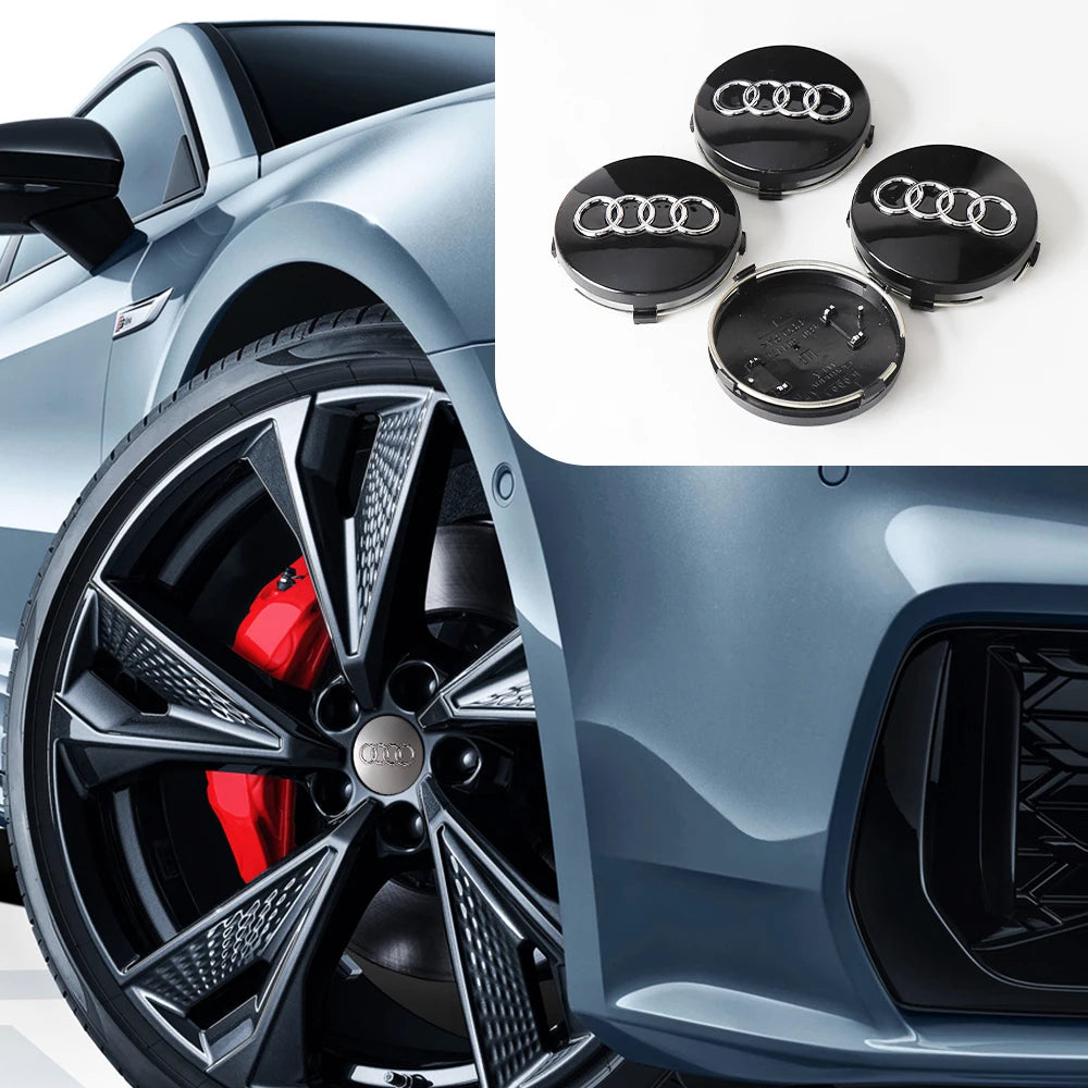 Close-up of black decorative wheel covers and hub caps for an Audi vehicle.