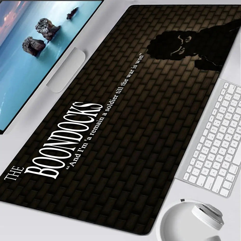 A black oversized gaming mouse pad featuring a silhouette of a character and text from The Boondocks