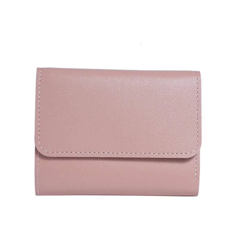 A light pink slim triple-fold PU leather wallet shown from the front.