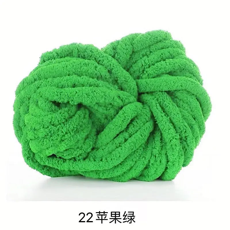 A ball of bright green chunky acrylic yarn for knitting and crochet