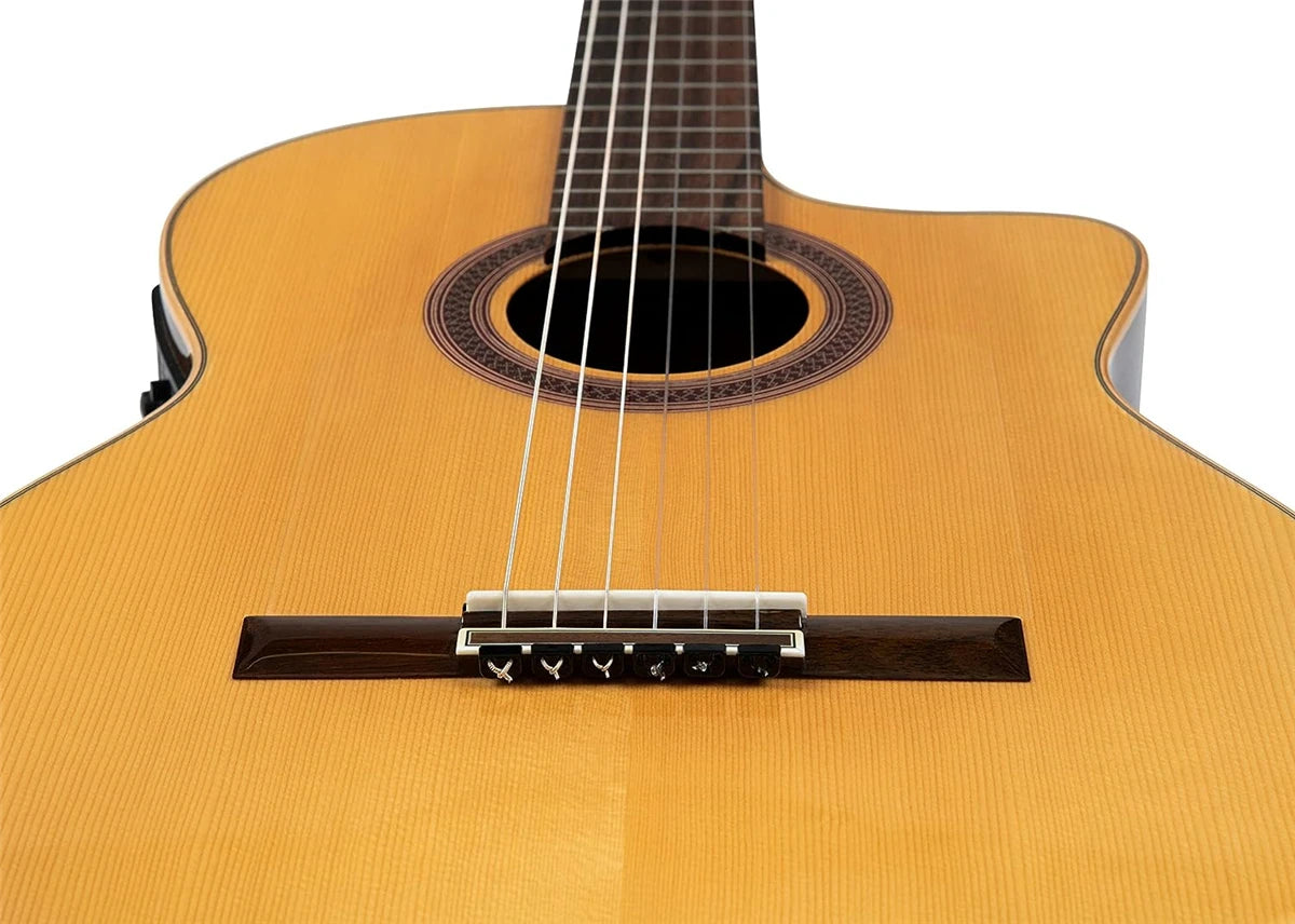 Close-up view of a classical guitar showing the bridge and strings.