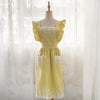 A yellow ruffled cotton linen kitchen apron with lace trim displayed on a mannequin.
