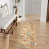A vintage bohemian trellis runner rug with floral patterns lies on a light wood floor.
