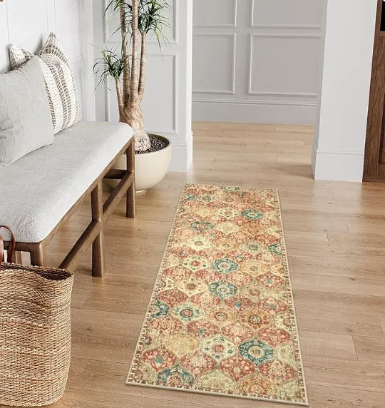 A vintage bohemian trellis runner rug with floral patterns lies on a light wood floor.