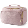 A light pink quilted travel toiletry bag with a zipper and handle.