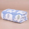 A fluffy blue and white cartoon elephant flannel pet blanket rolled up.