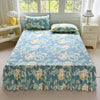 A light blue floral print bed skirt and pillowcase set with green foliage and yellow accents.