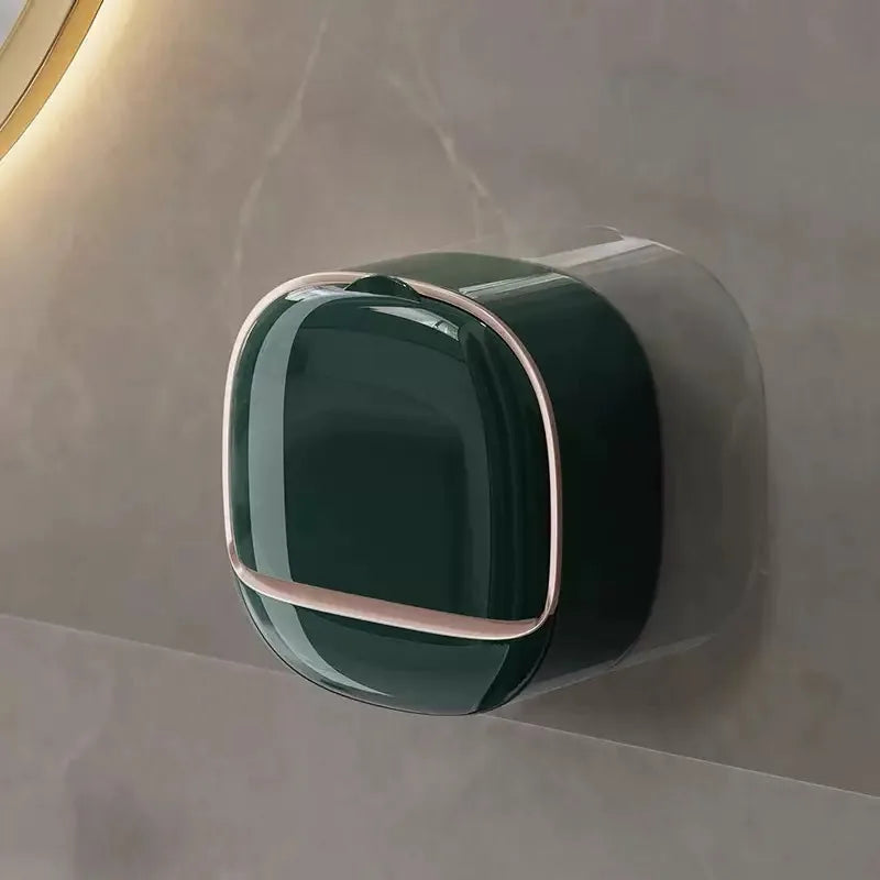 A dark green waterproof hanging soap holder with a silver trim mounted on a light gray wall.