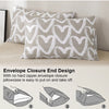 A close-up of a gray pillowcase with a white heart print, demonstrating the envelope closure end design.