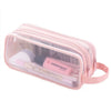 A clear pink mesh pencil case with a zipper holding various school and office supplies.