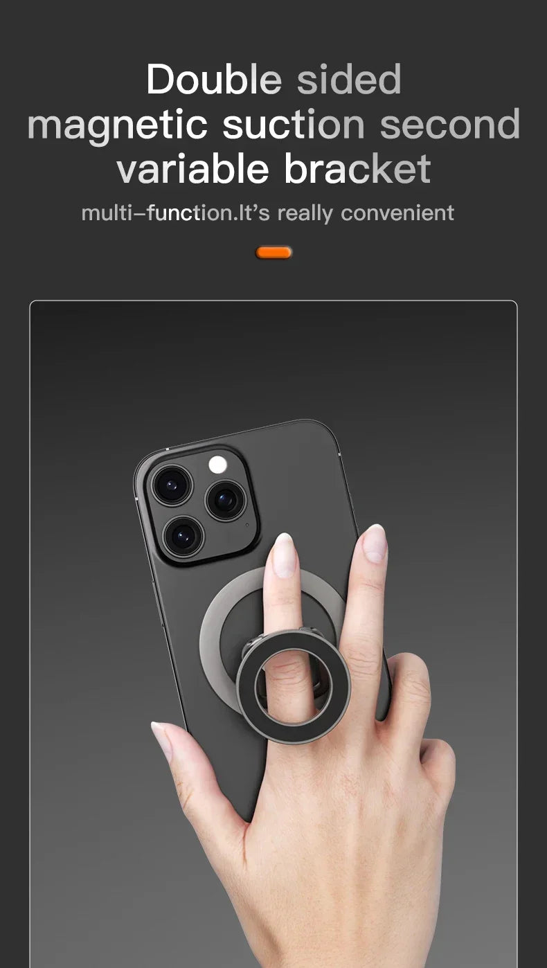 A hand holds a smartphone with a double-sided magnetic suction bracket attached to the back.