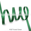 A green satin ribbon is shown coiled and unwound against a white background.