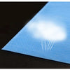 A sheet of light blue disposable bed linen with a bright white cloud pattern is shown on a dark surface.