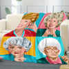 A colorful pop art blanket featuring portraits of the Golden Girls characters in various expressions.