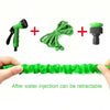 Green expandable magic hose with a spray nozzle and a flexible green tube shown being held by a hand.
